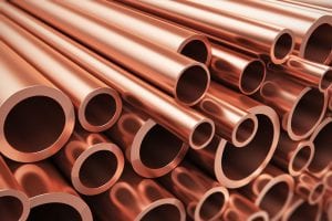New copper pipes are seen in a stack.